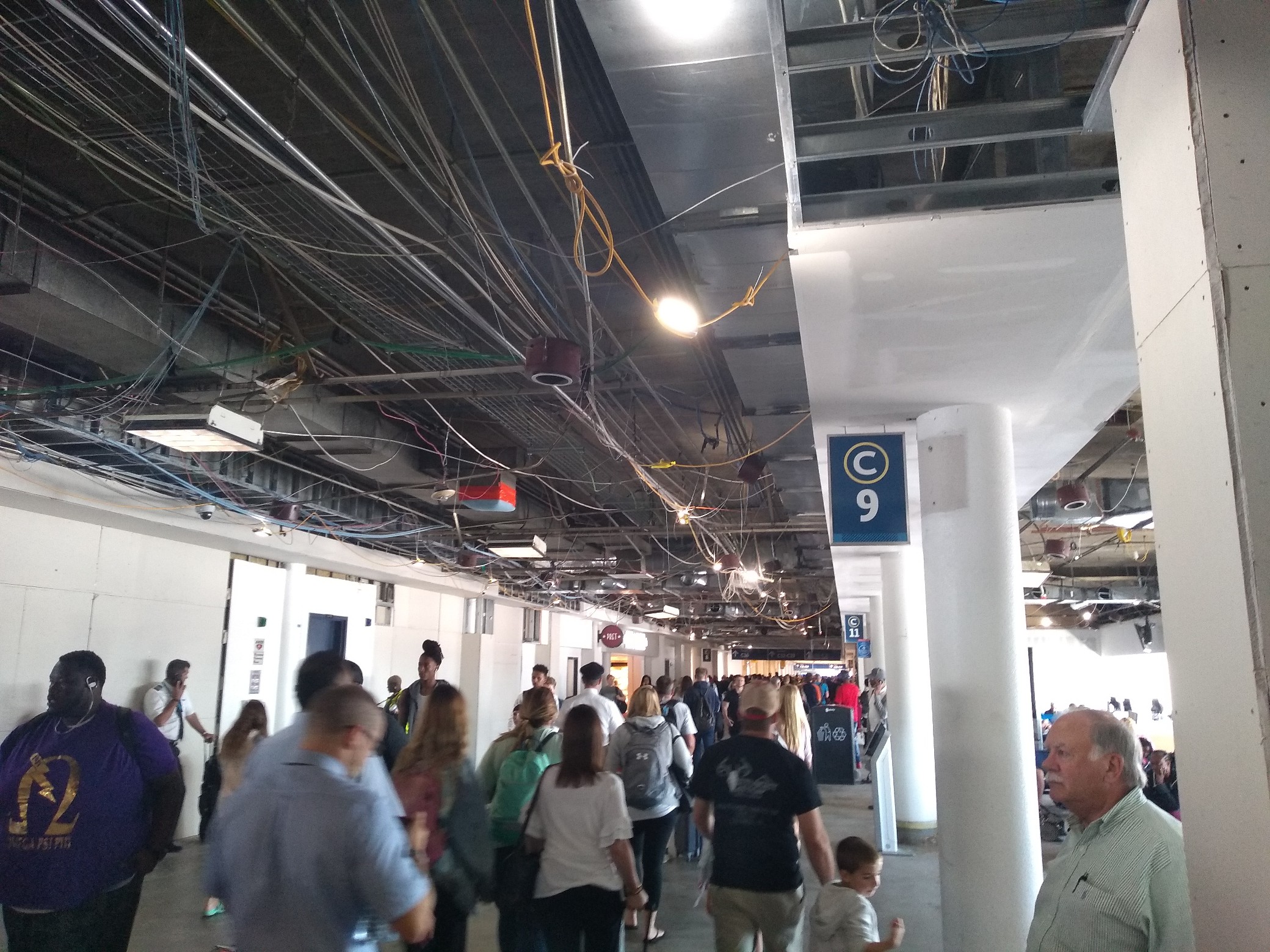 Ceiling with hanging construction lamps and exposed wiring and ductwork.