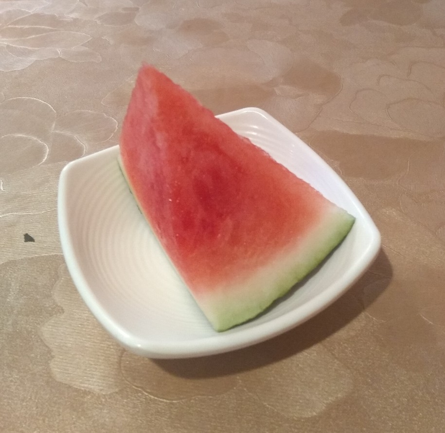 A chunk of watermelon in a dish.