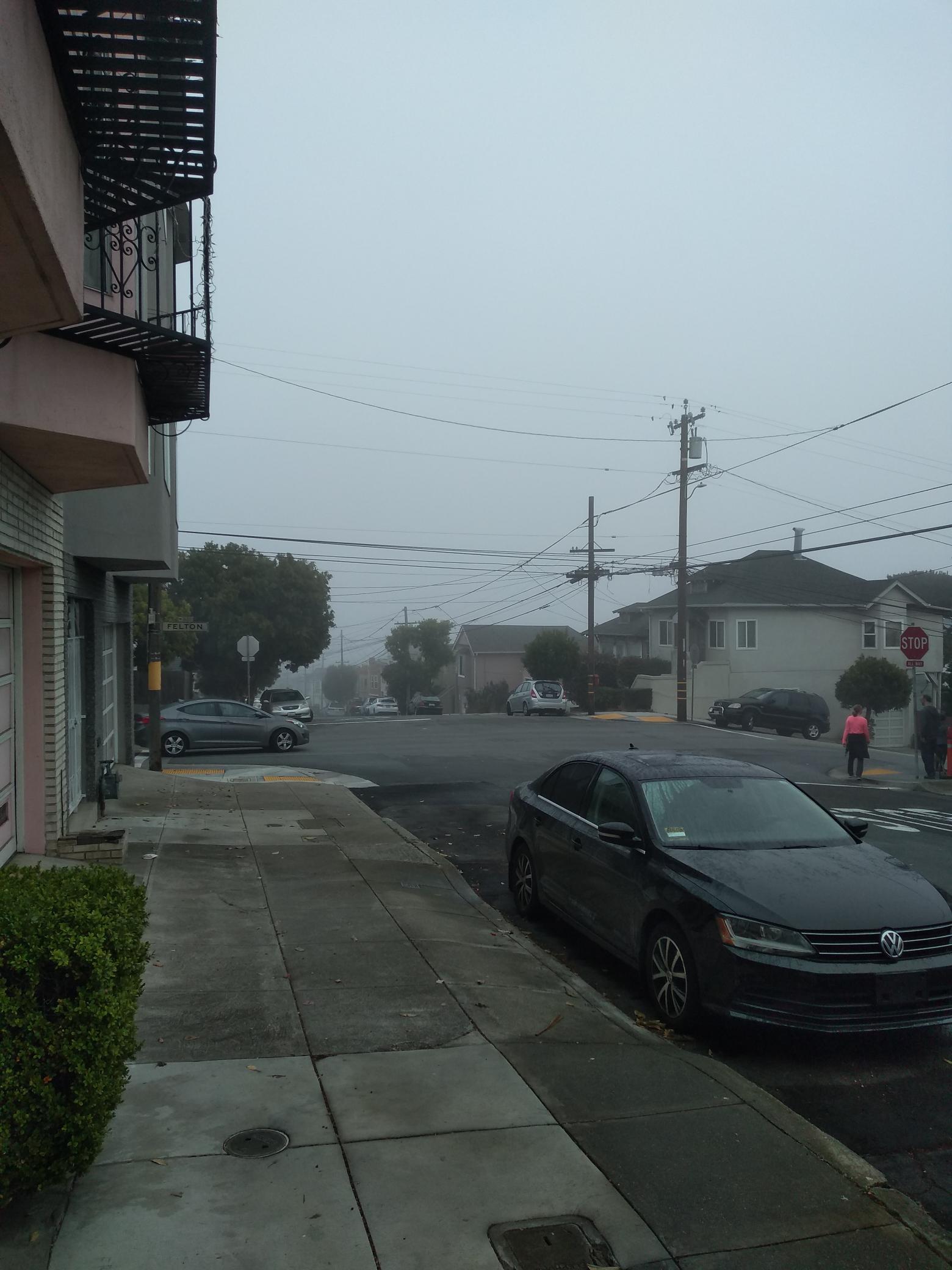 View down a street, which quickly fades to grey nothingness.