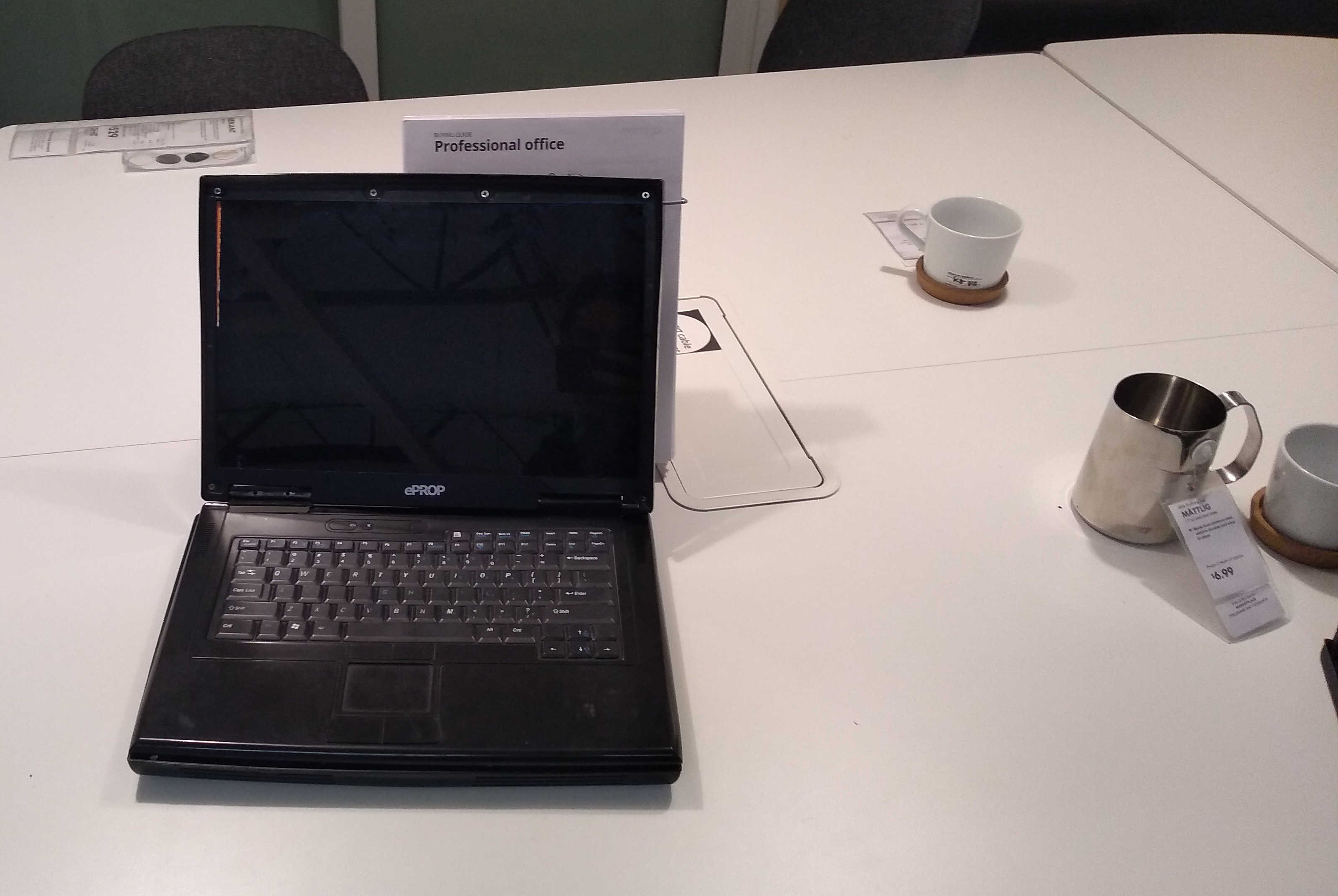 A fake laptop on a desk, prominently branded ‘ePROP’