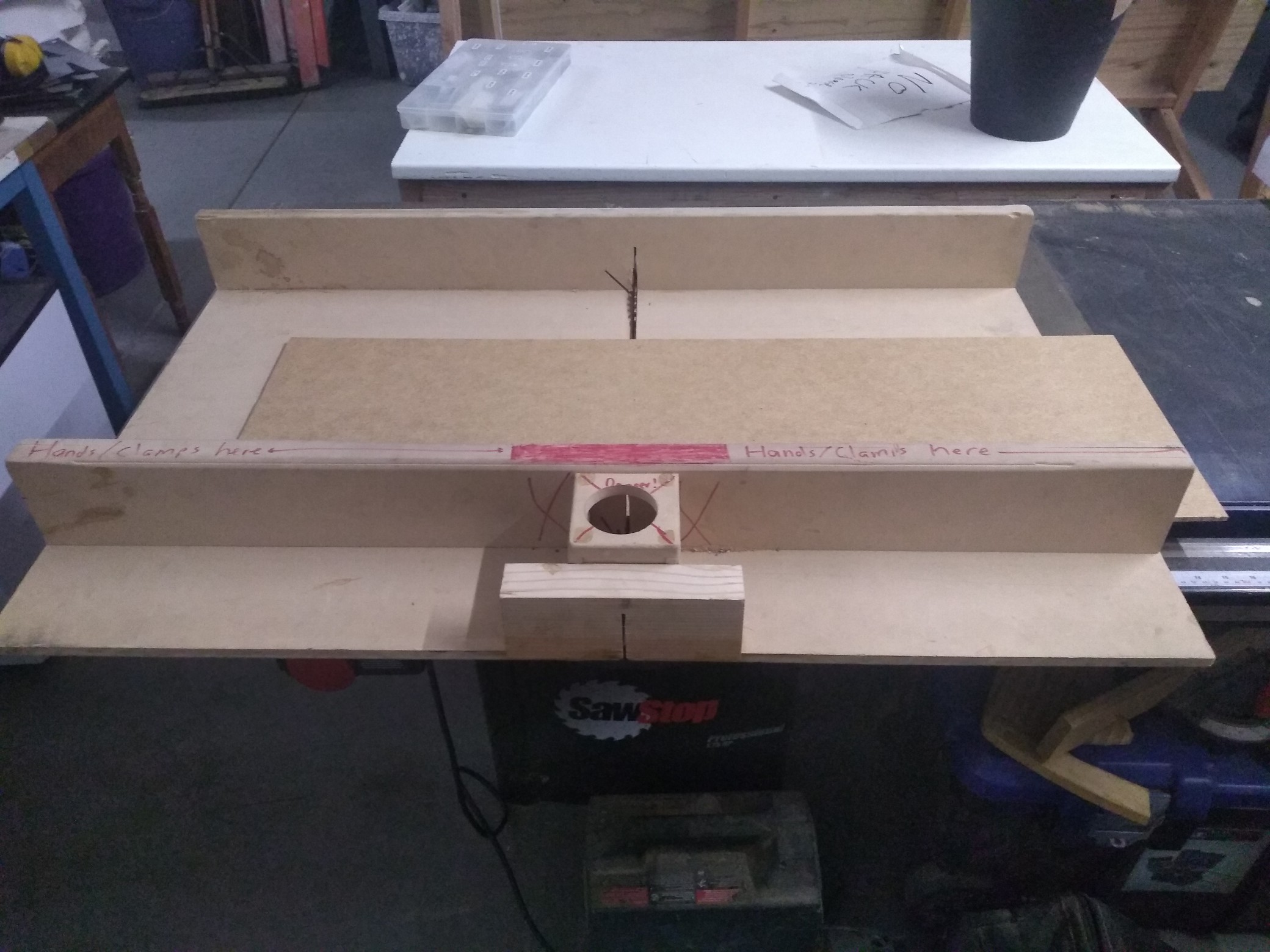 A chunk of hardboard in a handmade tablesaw sled.